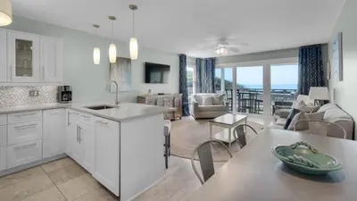 a kitchen and living room with a view of the ocean at Mistral 1 Bare Feet Retreat in Seacrest
