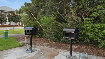 two electrical boxes sitting on the side of a yard at Mistral 1 Bare Feet Retreat in Seacrest