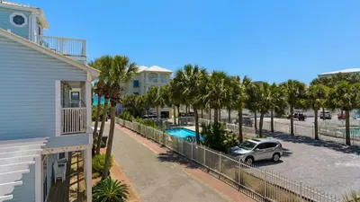a car parked in a parking lot next to a house at Moon Glow in Santa Rosa Beach
