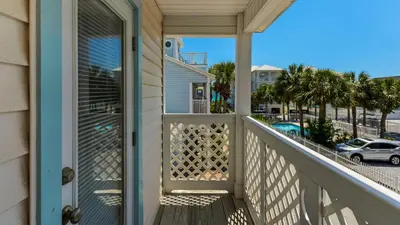 a balcony with a door and a view of a street at Moon Glow in Santa Rosa Beach