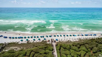an aerial view of a beach with umbrellas and people at Beachcrest 1101 in Santa Rosa Beach