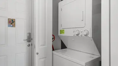 a white washer and dryer in a white kitchen at Beachcrest 1101 in Santa Rosa Beach