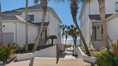 a house on the beach with palm trees at Emerald Hill 12A in Santa Rosa Beach