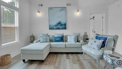 a living room with a couch and two chairs at Soul Shine in Santa Rosa Beach