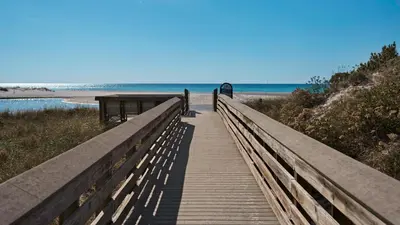 a wooden boardwalk leading to a beach with the ocean at Soul Shine in Santa Rosa Beach