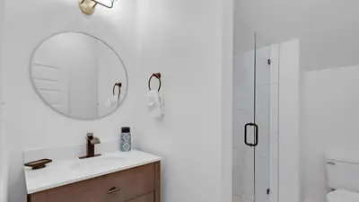 a bathroom with a sink and a mirror and a shower at Soul Shine in Santa Rosa Beach