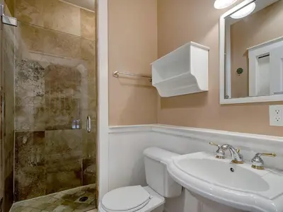 a bathroom with a toilet and a sink and a shower at Mon Petit Chateau in Panama City Beach