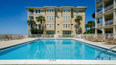 a swimming pool in front of a building at Mon Petit Chateau in Panama City Beach