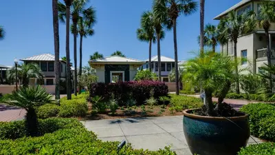 a resort with palm trees and a building at Mon Petit Chateau in Panama City Beach