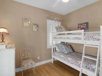 a room with two bunk beds and a chair at Mon Petit Chateau in Panama City Beach