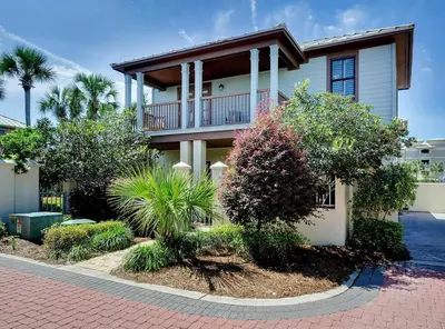 a large house with trees and bushes in front of it at Mon Petit Chateau in Panama City Beach