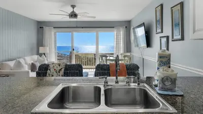 a kitchen with a sink and a view of the ocean at Mistral 6 in Seacrest