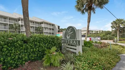 a sign in front of a resort with a building at Mistral 6 in Seacrest