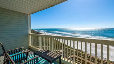 a porch with two benches and the ocean at Mistral 10 in Seacrest