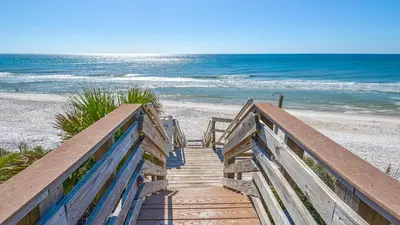 a staircase leading to a beach with the ocean at Mistral 10 in Seacrest