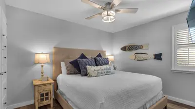 a bedroom with a bed with a ceiling fan at Beachwood Villas 4G in Santa Rosa Beach