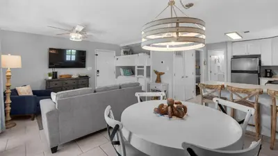 a kitchen and living room with a table and a couch at Beachwood Villas 4G in Santa Rosa Beach