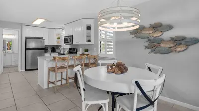 a kitchen and dining room with a table and chairs at Beachwood Villas 4G in Santa Rosa Beach
