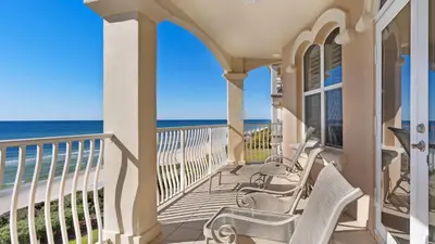 a porch with chairs and the ocean in the background at Monterey Condos A302 in Panama City Beach