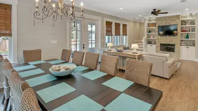 a dining room and living room with a table and chairs at Blue Bungalow in Santa Rosa Beach
