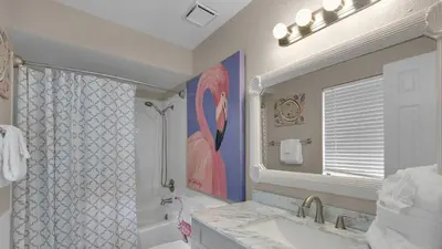 a bathroom with a shower and a sink and a mirror at Beachfront Condo II 202A - Out of the Blue in Santa Rosa Beach