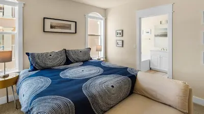 a bedroom with a bed with a blue comforter at Monterey Condos B302 in Panama City Beach