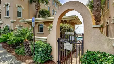 a gate to a building with a sign in front of it at Monterey Condos B302 in Panama City Beach