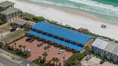 an overhead view of a building with a blue roof next to the beach at Blue Nine 9 in Panama City Beach