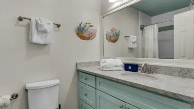 a bathroom with a sink and a mirror at Blue Nine 9 in Panama City Beach