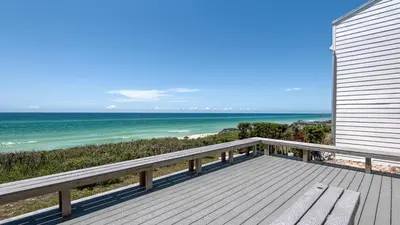 a wooden balcony with a view of the ocean at Blue Nine 9 in Panama City Beach