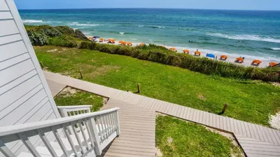 a staircase leading to the beach with umbrellas at Blue Tide 3B in Panama City Beach