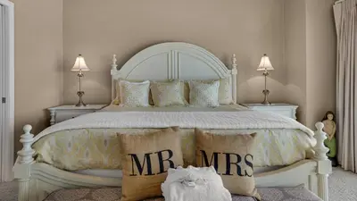 a bedroom with a white bed with mens pillows at Blue Tide 3B in Panama City Beach