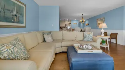 a living room with a couch and a table at Blue Tide 3B in Panama City Beach