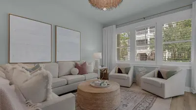 a living room with white furniture and a chandelier at Resting Beach Face in Rosemary Beach