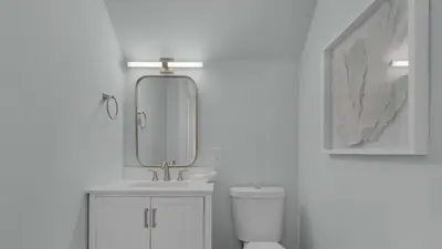 a bathroom with a sink and a mirror over a toilet at Resting Beach Face in Rosemary Beach