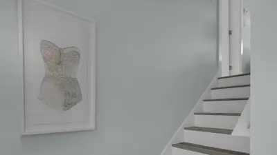 a stairway with a map of ireland on the wall at Resting Beach Face in Rosemary Beach