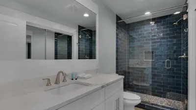 a bathroom with a sink and a toilet and a shower at Resting Beach Face in Rosemary Beach