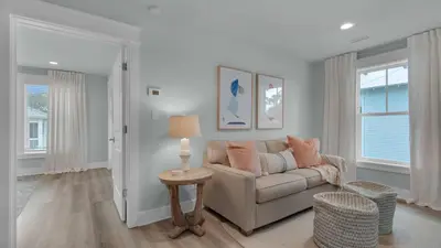 a living room with a couch and a table at Resting Beach Face in Rosemary Beach