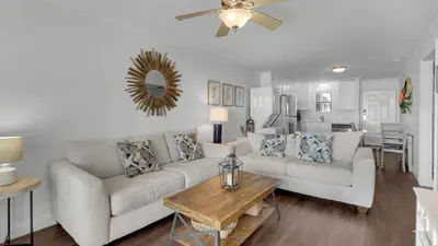 a living room with a couch and a table at Beachside Condo 1 in Santa Rosa Beach