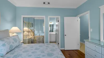 a bedroom with a bed and a dresser with a mirror at Palms A3 in Santa Rosa Beach