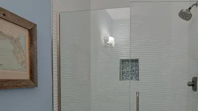 a shower with a glass door in a bathroom at Palms A12 in Santa Rosa Beach