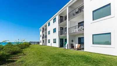 an apartment building with a lawn in front of it at Beachside Condo 11 in Santa Rosa Beach
