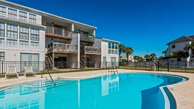 a swimming pool in front of a apartment building at Beachside Condo 14 in Santa Rosa Beach