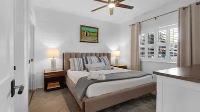 a bedroom with a bed and a ceiling fan at Palms C4 in Santa Rosa Beach