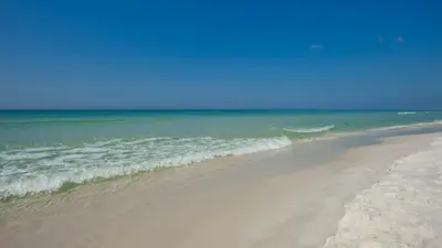 a beach with the ocean in the background at Palms C4 in Santa Rosa Beach