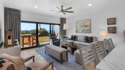 a living room with a couch and a table at Palms C4 in Santa Rosa Beach
