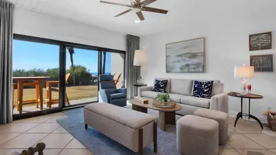 a living room with a couch and a table at Palms C4 in Santa Rosa Beach