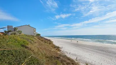 a beach with a building on the side of it at Palms C5 in Santa Rosa Beach