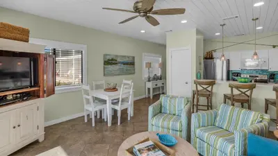 a living room with a couch and chairs and a table at Palms C5 in Santa Rosa Beach