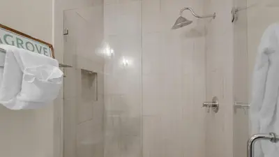 a bathroom with a shower with a glass door at Palms C7 in Santa Rosa Beach